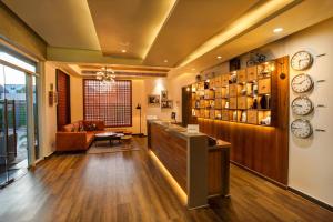 a lobby with clocks on the wall and a table at Four Points by Sheraton Chennai OMR in Chennai