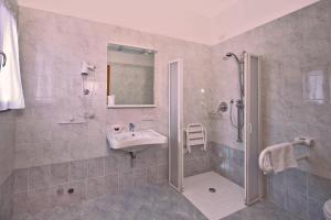 a bathroom with a sink and a shower at GH Hotel Piaz in Pozza di Fassa