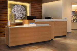 a reception desk in a lobby with a painting at Fairfield Inn & Suites by Marriott South Kingstown Newport Area in South Kingstown