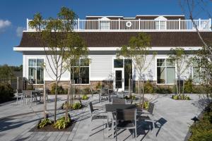 a building with tables and chairs in a courtyard at Fairfield Inn & Suites by Marriott South Kingstown Newport Area in South Kingstown