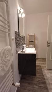 a bathroom with a sink and a mirror at Neferprod Apartments - IS - CAM 02 in Timişoara