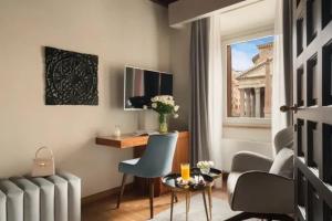 a room with a desk and chairs and a window at La Residenza del Sole al Pantheon in Rome