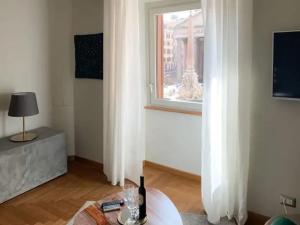 a living room with a table and a window at La Residenza del Sole al Pantheon in Rome