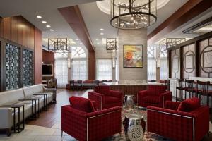 a lobby with red chairs and a bar at Fairfield Inn & Suites by Marriott Washington Downtown in Washington