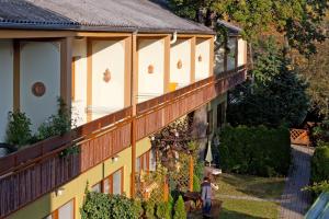 a man standing on the balcony of a house at Appartementhaus Witzmann in Bad Vöslau