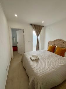 a bedroom with a large bed with two towels on it at Galagana Charm House in Golegã