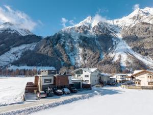 a resort with snow covered mountains in the background at Apart Gamper in Längenfeld