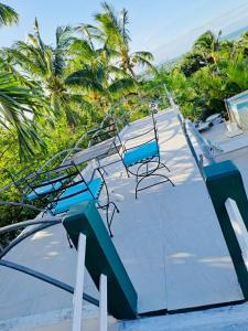 a slide at a resort with palm trees in the background at Residence Ma Vie Là Ltee in Le Morne