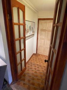 an open door to a hallway with a brick floor at Alojamientos en Torrealba, Recreo in Viña del Mar