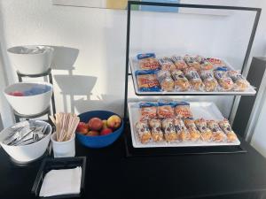 a refrigerator filled with food and a bowl of apples at Park Inn by Radisson, Fort Collins in Fort Collins