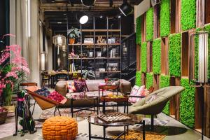 a living room with a couch and a table at Moxy Poznań Airport in Poznań