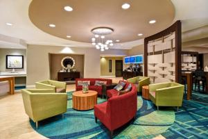 リンティカム・ハイツにあるSpringHill Suites by Marriott Baltimore BWI Airportのカラフルな椅子とテーブルが備わるホテルロビー