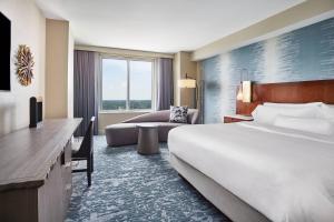 a hotel room with a bed and a couch at The Westin Virginia Beach Town Center in Virginia Beach