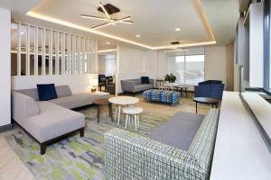 a living room with two couches and a table at TownePlace Suites by Marriott Hamilton in Hamilton