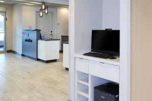 a room with a desk with a computer on it at TownePlace Suites by Marriott Hamilton in Hamilton