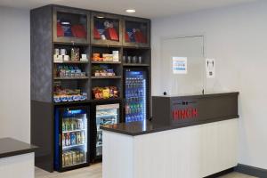 a grocery store with two large refrigerators and a counter at TownePlace Suites by Marriott Hamilton in Hamilton