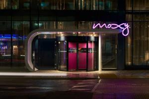 a neon sign on the front of a building at Moxy Southampton in Southampton