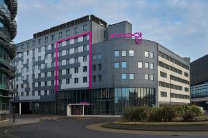 a large building with a pink sign on it at Moxy Southampton in Southampton