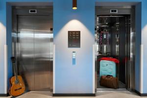 a couple of elevators in a store with a guitar at Moxy Sophia Antipolis in Biot