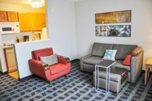 a living room with a couch and a chair at TownePlace Suites by Marriott Albuquerque Airport in Albuquerque