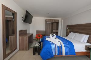 PRIVATE ROOMS - DOWNTOWN AREQUIPA - Adults Only في أريكيبا: غرفة نوم بسرير وبطانية زرقاء وبيضاء