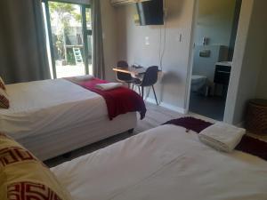 A bed or beds in a room at Cornerstone Guesthouse Alk Van Zyl