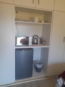 A kitchen or kitchenette at Cornerstone Guesthouse Alk Van Zyl