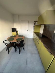 une petite chambre avec une table et une cuisine dans l'établissement Vaste appartement avec parking gratuit et espace de travail, à Illkirch-Graffenstaden