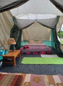 A bed or beds in a room at Bueng Pai Farm บึงปายฟาร์ม