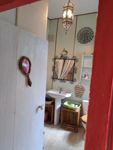 a bathroom with a sink and a mirror at Terra-Crystal in Rochefort