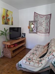 a bedroom with a bed and a tv on a table at Terra-Crystal in Rochefort