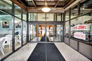 a store front with glass doors and white chairs at Quality Hotel & Suites At The Falls in Niagara Falls