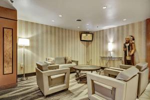 a waiting room with chairs and a table and a statue at Quality Hotel & Suites At The Falls in Niagara Falls