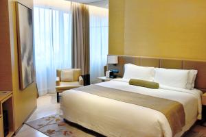 Voodi või voodid majutusasutuse Fraser Suites Guangzhou toas