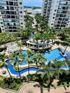 an aerial view of a resort with palm trees at Barra Family Resort com piscina e spa, 2 quartos in Rio de Janeiro