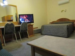 A television and/or entertainment centre at Glenelg Motel