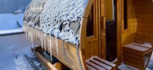 a building covered in snow with icicles on it at Sun Chalet in Schladming