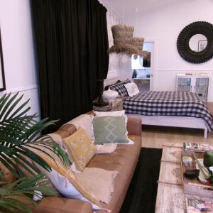 a living room with a couch and a bed at Studio 34 - Nelson Bay in Nelson Bay