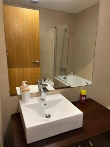 a bathroom with a white sink and a mirror at Ramona in Aveiro