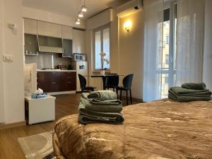 a room with a bed with towels on it at Valverde Apartment and Rooms in Verona