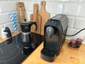 a black coffee maker sitting on top of a counter at Apartament Horizon in Gdynia