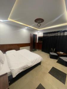 Mussiaree Hotel में एक कमरे में एक या कई बेड