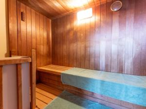 a sauna with a bench in a wooden room at Tabist Shizukuishi Resort Hotel in Shizukuishi