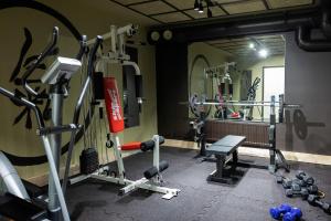 a gym with tread machines and a bench and a mirror at Strandnäs Hotell in Mariehamn