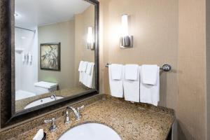 a bathroom with a sink and a mirror at Embassy Suites by Hilton Bloomington/Minneapolis in Bloomington