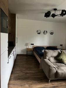 a living room with a bed and a couch at IQ Apartments in Prešov