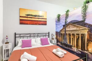 ein Schlafzimmer mit einem großen Bett mit rosa Kissen in der Unterkunft Deluxe Apartments Pantheon in Rom