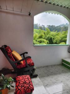 a chair sitting in a room with a window at Hotel Casa Quinta Salento in Salento