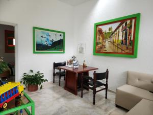 a room with a table and a toy train on the wall at Hotel Casa Quinta Salento in Salento