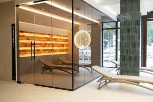 a glass partition in a room with two chairs at Continental SPA Resort in Bukovel